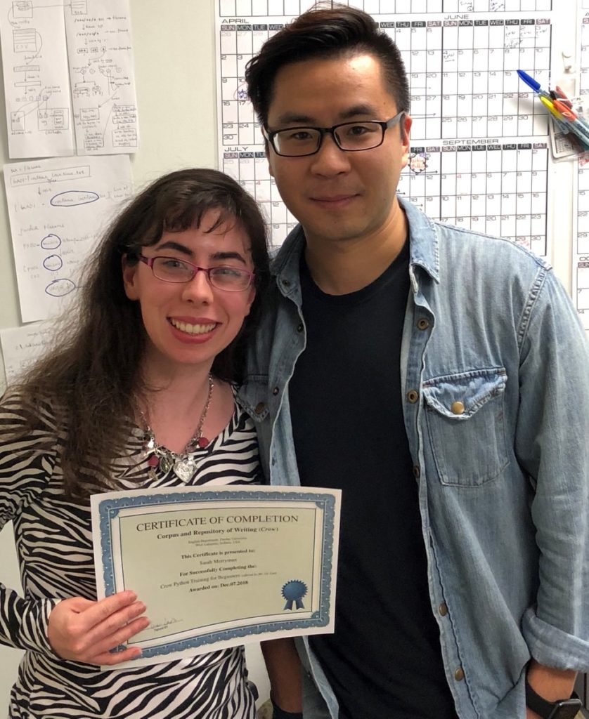 Sarah proudly displays her certificate for completing the introductory Python coding course with teacher, and fellow Crowbird Ge Lan. 
